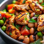 Colorful bowl showcasing black-eyed peas, chicken, and fresh parsley garnishing.