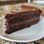 A detailed side profile of a chocolate cake, revealing its luscious layers and creamy frosting.