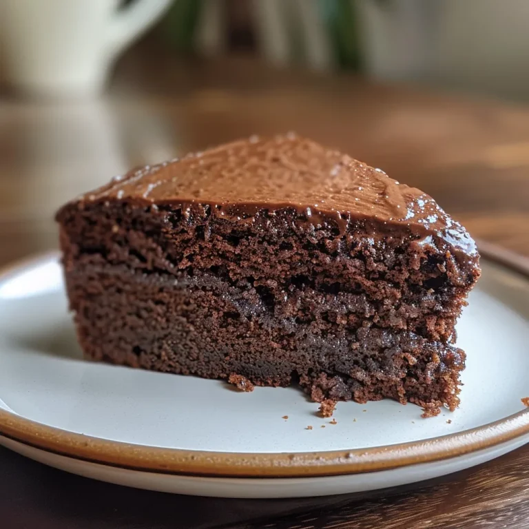 Effortless Indulgence: Crafting the Ultimate Blender Chocolate Cake Juicy slice of chocolate cake showcasing layers and a shiny chocolate glaze.