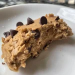 A detailed photo of Cottage Cheese Cookie Dough, highlighting chocolate chips and a creamy appearance.