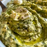 Textured Green Goddess Feta Dip garnished with parsley, served on a wooden surface.
