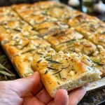 Juicy rosemary garlic focaccia showcasing a crispy crust and soft interior.