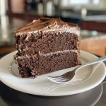 Juicy chocolate cake captured in close-up, highlighting its moist interior and decadent topping.