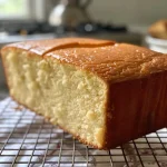 Detailed view of a cut slice of Vanilla Pound Cake highlighting its fluffy interior.