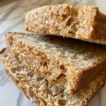 Detailed image of whole wheat bread emphasizing its rustic texture and warm color.