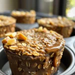 Juicy baked oatmeal cups displayed on a wooden surface with a rustic background.