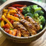 Close-up view of a Balanced Chicken & Veggie Power Bowl featuring chicken and colorful vegetables.