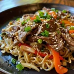 Close-up of a vibrant Beef Chow Mein dish, showcasing tender beef and colorful vegetables.