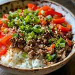 Close-up view of a Beef and Pepper Rice Bowl with colorful peppers and ground beef.