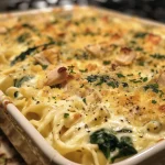 Delicious baked dish featuring creamy spinach and shredded chicken with a golden crust.