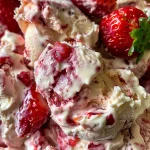 Close-up view of frozen yogurt strawberry bark with vibrant red strawberries.