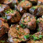 Mouth-watering garlic butter steak bites displayed in a rustic setting.
