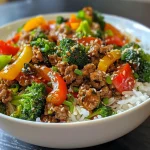 Side view of a delicious ground beef teriyaki stir fry showcasing fresh vegetables and glossy sauce.