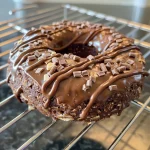 Delicious healthy donuts featuring a chocolate glaze, sprinkles, and coconut flakes against a rustic background.