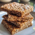 Deliciously baked healthy oatmeal bars featuring bits of fruit and seeds.