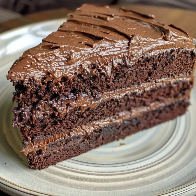 Decadence Unleashed The Art of Baking Matilda Chocolate Cake Close-up side view of a luscious chocolate cake topped with dark chocolate frosting.