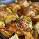 Colorful one-pan meal featuring chicken, potatoes, and fresh herbs.