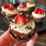 ['Close-up of chocolate strawberry cheesecake dessert cups showing layers of chocolate cookies, cream cheese filling, and strawberry puree.', 'Side view of decadent dessert cups featuring chocolate cookie crust and vibrant strawberry topping.', 'Delicious chocolate strawberry cheesecake cups with creamy layers and a garnish of fresh strawberries.', 'Rich dessert cups filled with chocolate cheesecake and drizzled with strawberry sauce, displayed on a smooth surface.']