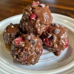 ['Close-up view of chocolate strawberry protein bites, showing texture and ingredients.', 'Side view of delicious protein bites made with chocolate and strawberries, displayed on a surface.', 'Juicy chocolate strawberry protein bites in a close-up photograph, highlighting their colorful appearance.', 'Detailed image of protein bites featuring chocolate and strawberry pieces, taken with an iPhone.']
