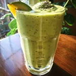 ['Close-up view of a creamy avocado smoothie in a glass, with vibrant green color and garnished with spinach.', 'Side view of a delicious, thick avocado smoothie in a clear glass, showcasing its creamy texture and rich green hue.', 'Detail shot of a creamy smoothie made with avocado, frozen banana, and spinach, served in a stylish glass.', 'A luscious avocado smoothie in a glass, highlighting its creamy consistency and fresh ingredients.']