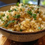 ['Close-up side view of creamy garlic Parmesan quinoa garnished with fresh parsley.', 'A dish of creamy garlic Parmesan quinoa presented in a bowl, highlighting its creamy texture.', 'Juicy, delicious creamy garlic Parmesan quinoa with minced garlic visible, served from a bowl.', 'Side view of a creamy garlic Parmesan quinoa dish, showcasing rich flavors and ingredients.']