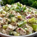 ['A vibrant close-up of Easy Turkey Salad featuring diced turkey, celery, and red onion.', 'Juicy Turkey Salad displayed in a bowl, highlighting its fresh ingredients and creamy texture.', 'A side view of a colorful Easy Turkey Salad with visible chunks of turkey, celery, and a creamy dressing.', 'An appetizing close-up of a turkey salad mix, showcasing various ingredients blended together.']