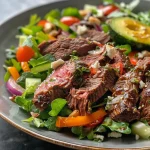['A vibrant low-carb beef salad featuring various vegetables and lean beef cuts.', 'Close-up view of a nutritious beef salad with greens, colorful veggies, and toppings.', 'A detailed shot of a healthy salad with juicy beef, mixed greens, and a variety of toppings.', 'An appetizing low-carb beef salad showcasing fresh ingredients including avocado and cherry tomatoes.']