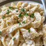 ['Close-up view of a bowl filled with High Protein Garlic Parmesan Pasta, showcasing creamy sauce and garnishes.', 'Side angle of a delicious High Protein Garlic Parmesan Pasta dish, highlighting its ingredients and textures.', 'Juicy, creamy High Protein Garlic Parmesan Pasta captured in a detailed close-up from a smartphone.', 'Vibrant bowl of High Protein Garlic Parmesan Pasta, featuring garlic and cheese with a sprinkle of parsley.']