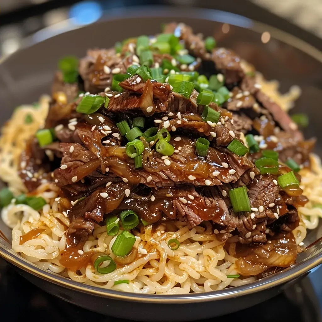 ['Close-up view of a plate filled with honey soy crispy beef and noodles topped with spring onions.', 'Side view of juicy honey soy crispy beef and noodles on a rustic plate.', 'Appetizing dish featuring crispy beef drenched in honey soy sauce served over noodles.', 'Close-up of delicious honey soy beef and noodles garnished with sliced spring onions.']