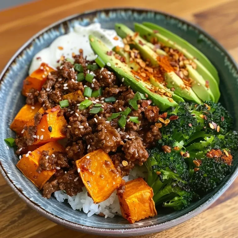 ['A close-up view of a hot honey beef bowl featuring vibrant ingredients like sweet potatoes, avocado, and tenderstem broccoli.', 'Juicy lean beef mince bowl topped with hot honey sauce, surrounded by colorful vegetables and cottage cheese.', 'Side view of a hearty hot honey beef bowl showcasing cooked sweet potatoes, fresh avocado, and broccoli.', 'Delicious bowl filled with hot honey beef, sweet potatoes, cottage cheese, and garnished with avocado slices.']