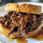 ['Juicy pulled beef sandwiches dripping with sauce on a wooden board.', 'Close-up view of honey bourbon pulled beef sandwiches ready to be served.', 'Savory pulled beef piled high on toasted buns, garnished with fresh herbs.', 'Succulent crockpot honey bourbon pulled beef sandwiches with melted cheese.']