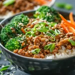 ['Close-up of a tasty ground turkey rice bowl with vibrant vegetables.', 'Juicy ground turkey over fluffy jasmine rice with broccoli and carrots.', 'Side view of a colorful rice bowl featuring ground turkey and fresh greens.', 'Deliciously arranged ground turkey rice bowl topped with green onions.']