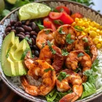 ['Close-up view of a colorful shrimp taco bowl with fresh ingredients.', 'Delicious shrimp taco bowl highlighting shrimp, vegetables, and creamy sauce.', 'Juicy shrimp taco bowl featuring vibrant toppings and creamy chipotle drizzle.', 'Side view of a shrimp taco bowl filled with rice, shrimp, and fresh garnishes.']