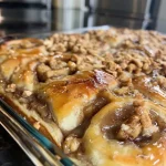 Close-up of Apple Crisp Cinnamon Rolls with a golden-brown topping.