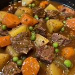 Close-up of a hearty beef stew with vegetables in a bowl.