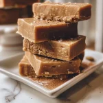A close-up, side view of a glossy piece of Dirty Chai Spiced Fudge showcasing its rich texture.