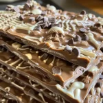 Close-up view of graveyard chocolate bark with skeleton candy pieces.