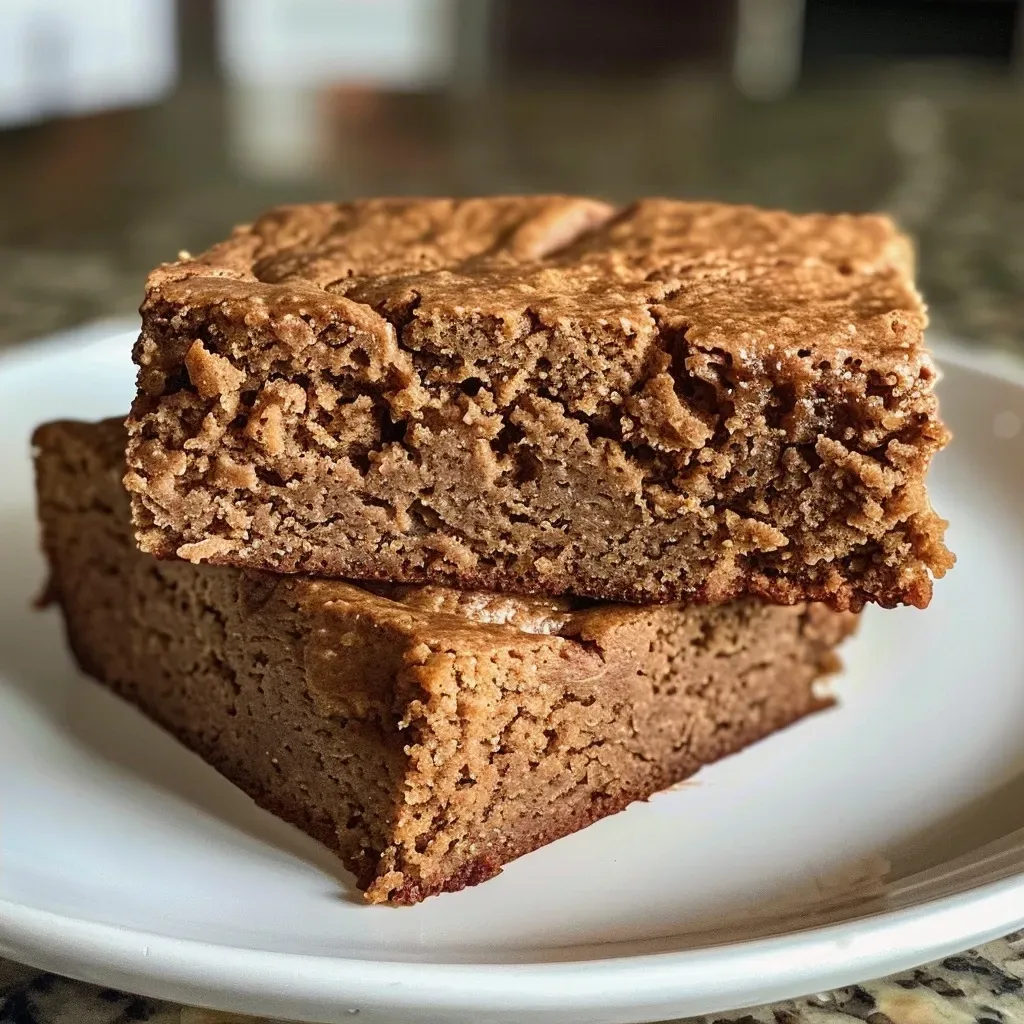 A delectable slice of high protein gingerbread cake with a rich brown color and visible spices.