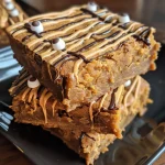 Close-up view of Mummy Pumpkin Blondies decorated with candy eyes.