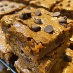 Close-up view of moist pumpkin blondies with chocolate chips.