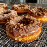 Close-up view of a freshly baked Pumpkin Streusel Donut topped with a crumbly streusel.