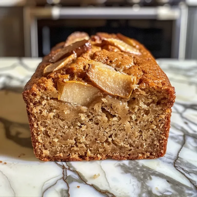 Embracing Comfort: The Irresistible Allure of Spiced Pear Bread Close-up view of spiced pear bread showcasing a golden-brown crust and visible pear chunks.