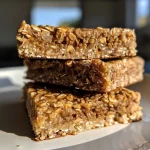 Close-up side view of spiced pear oatmeal protein bars showing a moist texture.
